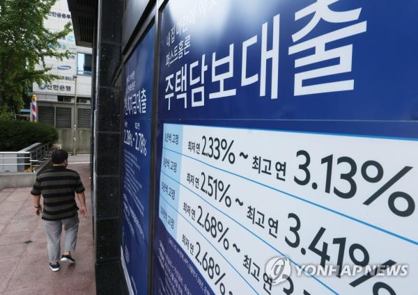 This file photo, taken Oct. 3, 2021, shows signs a<em></em>bout a bank's loan programs that were put up on the exterior of a lender in Seoul. South Korea's financial regulator is reviewing further tightening rules on household loans in a bid to curb the fast growth of household debt. (Yonhap)