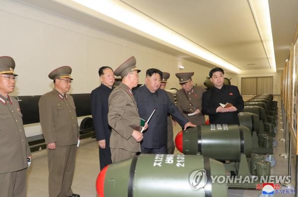 This photo, carried by North Korea's official Korean Central News Agency on March 28, 2023, shows North Korean leader Kim Jong-un (4th from R) guiding the country's nuclear weapo<em></em>nization project the previous day, while calling for expanding the production of weapons-grade nuclear materials. (For Use o<em></em>nly in the Republic of Korea. No Redistribution) (Yonhap)