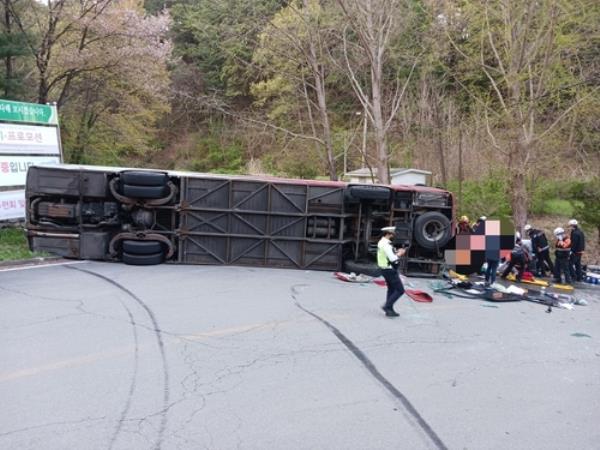 A tour bus falls on its side in Chungju, North Chungcheong Province, on April 13, 2023, in this photo provided by North Chungcheong Province Fire Station. (PHOTO NOT FOR SALE) (Yonhap)