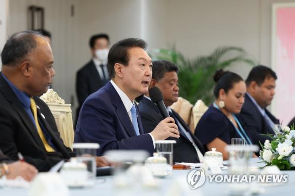 President Yoon Suk-yeol (2nd from L) speaks during a meeting with prime ministers and foreign ministers from 12 Pacific island countries at the presidential office in Seoul on Oct. 27, 2022, in this photo provided by the presidential office. They visited South Korea to attend the fifth Korea-Pacific Islands Foreign Ministers' Meeting. (PHOTO NOT FOR SALE) (Yonhap)