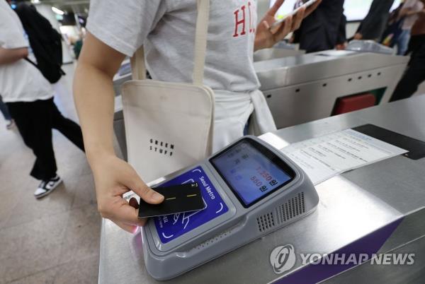 In this file photo, a passenger pays for a ride at a subway station in Seoul on May 17, 2023. (Yonhap)