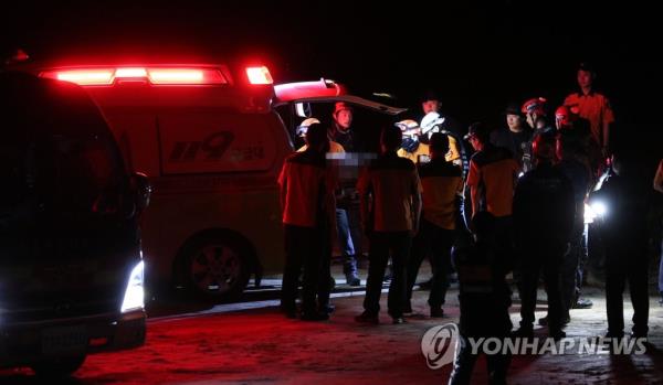 Rescue workers carry the body of a marine to an ambulance in Yecheon on July 19, 2023. He went missing earlier in the day after being swept away by a torrent while participating in search and rescue operations in the area. (Yonhap)