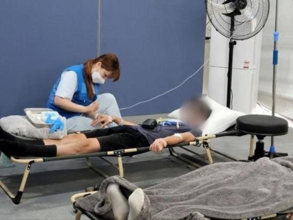 A medical worker on Samsung Group's medical team tends to a patient at the Saemangeum campsite for the World Scout Jamboree on South Korea's southwest coast, in this photo provided by Samsung Group on Aug. 6, 2023. (PHOTO NOT FOR SALE) (Yonhap)
