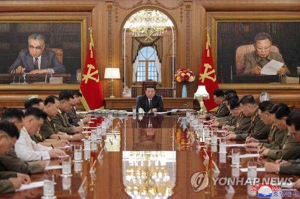 This photo, carried by the North's Korean Central News Agency on Aug. 10, 2023, shows North Korean leader Kim Jong-un (C) presiding over an enlarged meeting of the Central Military Commission of the ruling Workers' Party of Korea the previous day. (For Use o<em></em>nly in the Republic of Korea. No Redistribution) (Yonhap)