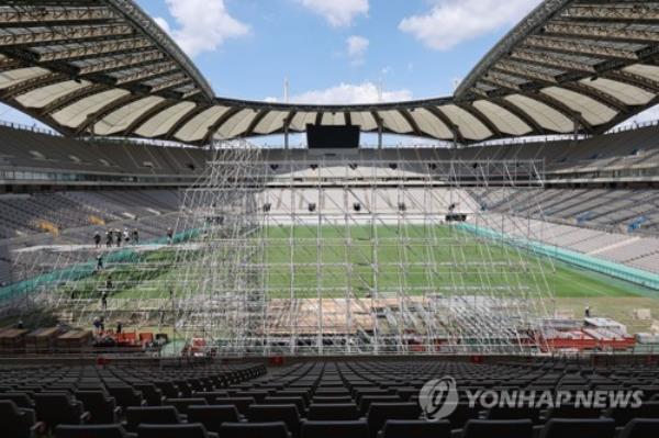 Workers set up a makeshift stage for the 