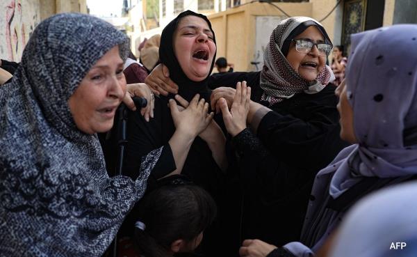 Women mourn during the funeral of members of the Abu Quta family who were killed in Israeli strikes on Palestinian city of Rafah