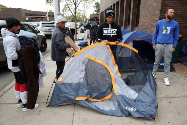 Venezuelan migrants sheltering outside the 11th District Chicago police station set up do<em></em>nated tents on Oct. 11, 2023.