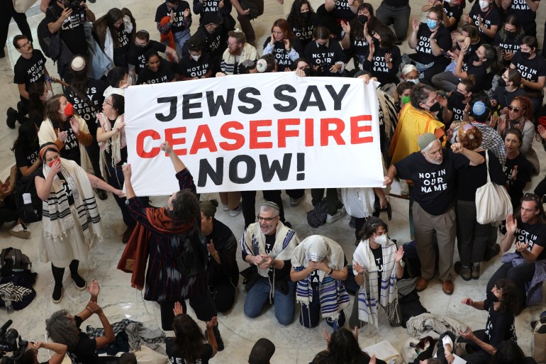 WASHINGTON, DC - OCTOBER 18: Protesters hold a demo<em></em>nstration in support of a cease fire in Gaza in the Cannon House Office Building on October 18, 2023 in Washington, DC. Members of the Jewish Voice for Peace and the IfNotNow movement staged a rally to call for a cease fire in the IsraelHamas war. Alex Wong/Getty Images/AFP (Photo by ALEX WONG / GETTY IMAGES NORTH AMERICA / Getty Images via AFP)