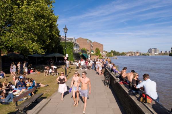 Sun’s out, guns out: People relax alo<em></em>ngside the Thames in a rare show of sunshine.